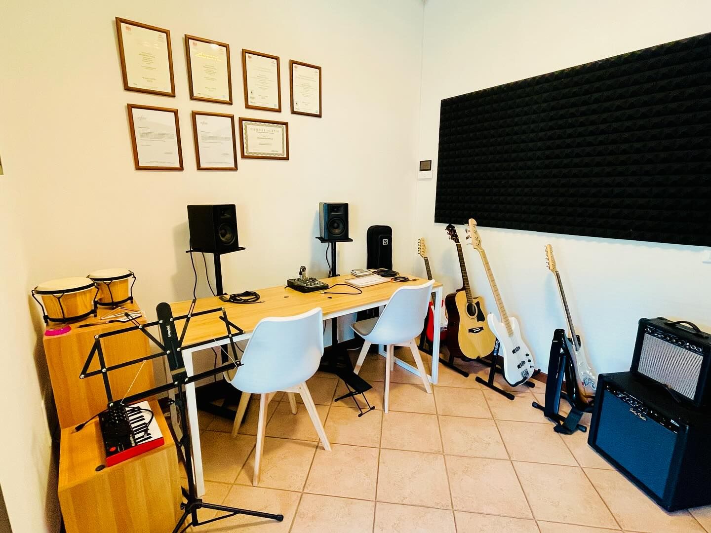 Music production studio room with instruments and equipment